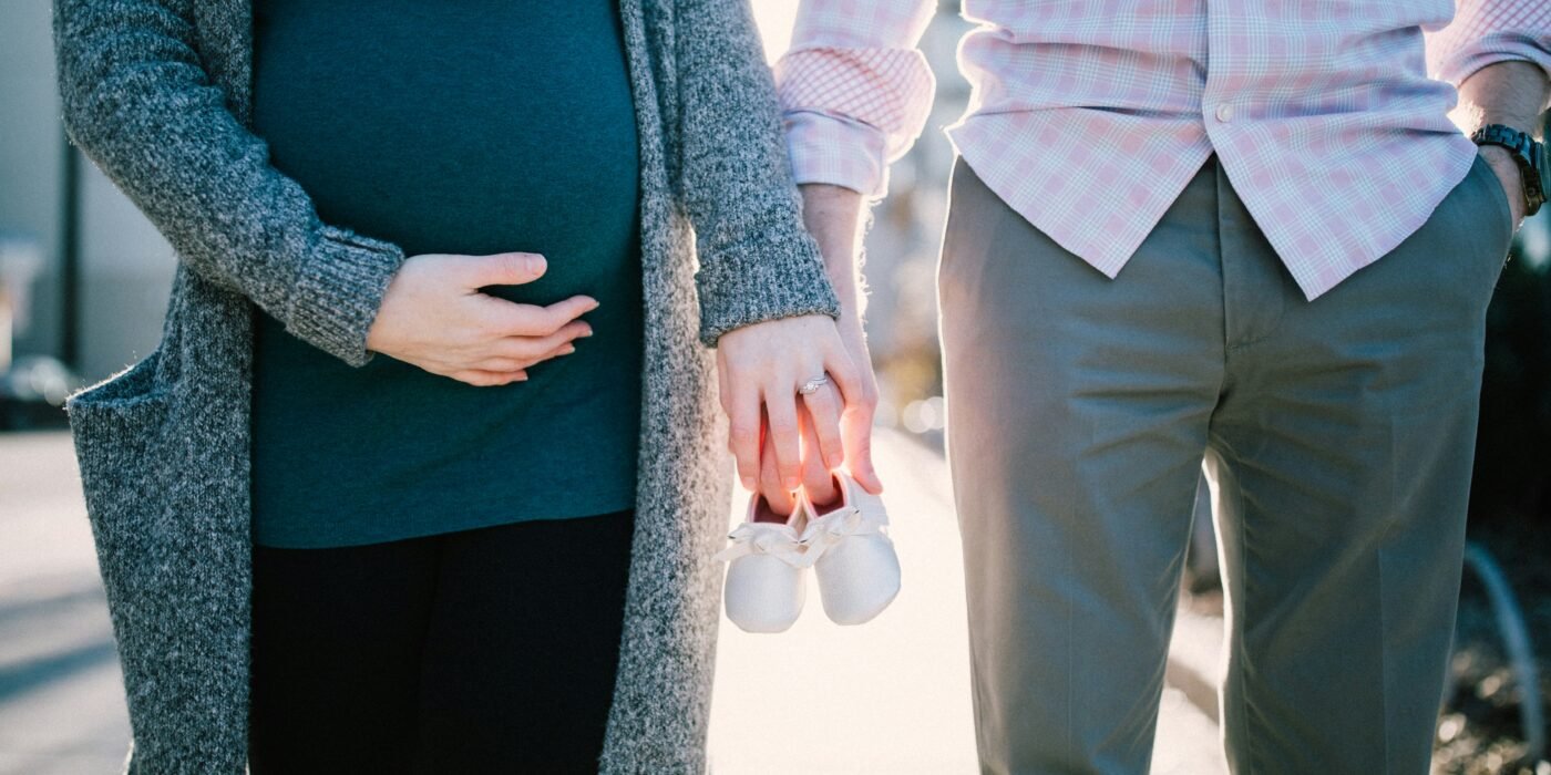 pregnant woman holds her husband