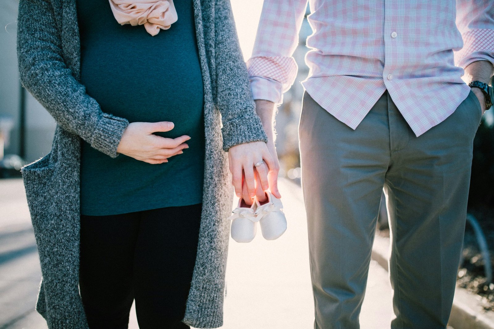 pregnant woman holds her husband